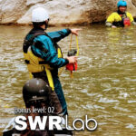 A certified swiftwater rescue instructor teaches a student how to safely get a kayaker across the waterduring the Level Up Kayak School Swiftwater Rescue Lab course.